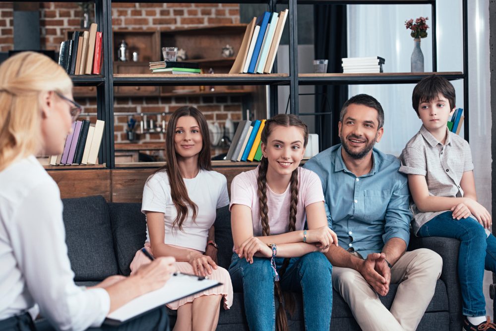 family sitting in therapist office