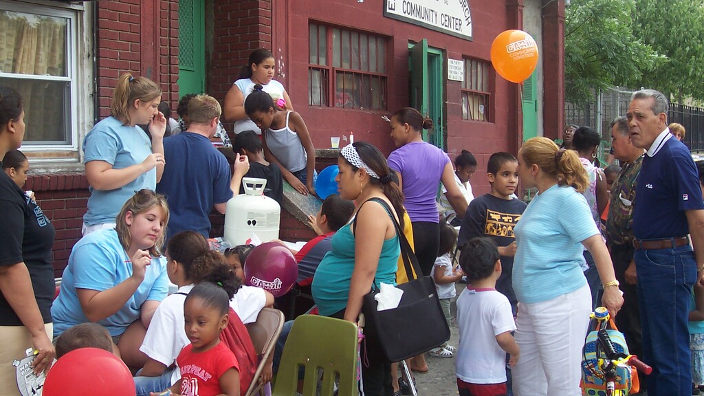 Two volunteers smiling while sorting toys