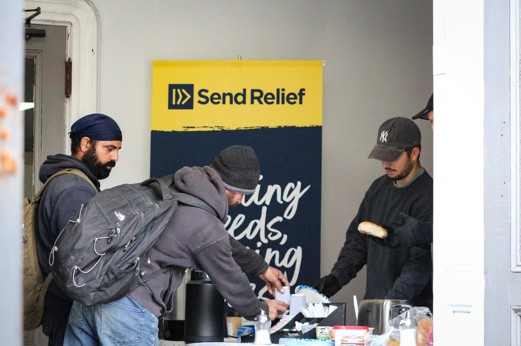 Three girls smiling with heads tilted toward one another
