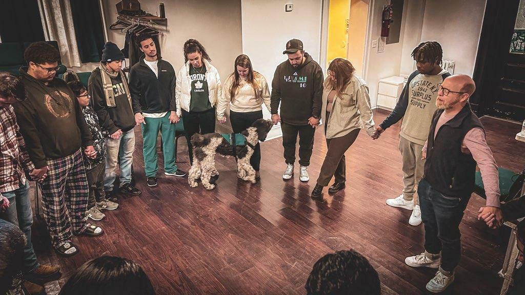 Volunteer and student playing game tossing a ball at a target