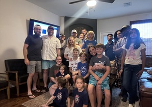 A group of church members gathered together in a home.