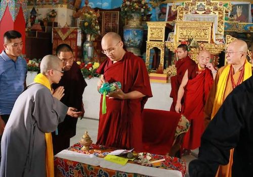 Photograph of Karmapa Ogyen Trinley Dorje with sprayer, 2016