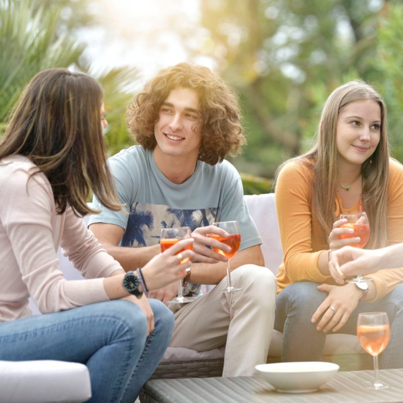 friends having a drink outside on a patio together