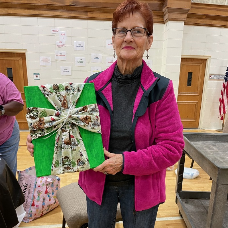 Miss Barbara showing her beautiful cross she made.